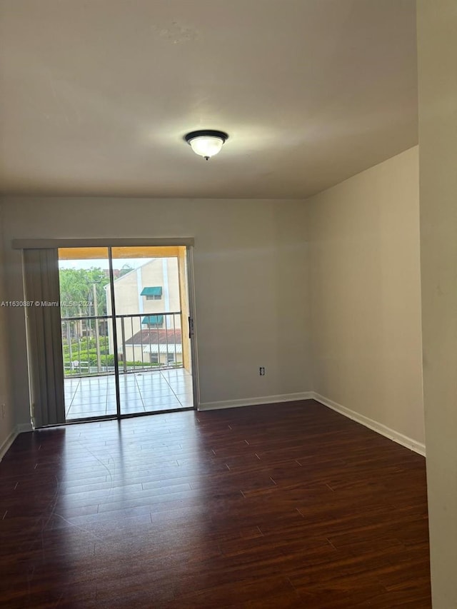 spare room with dark hardwood / wood-style flooring