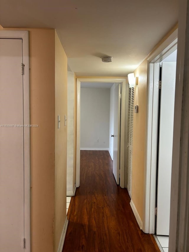 corridor featuring dark hardwood / wood-style flooring