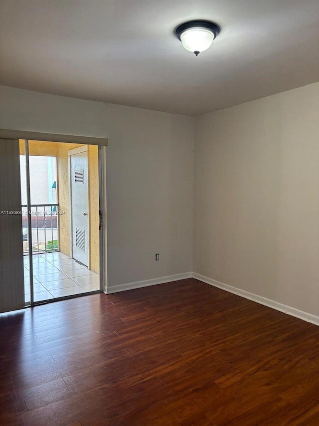 unfurnished room with dark hardwood / wood-style floors