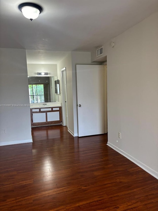 unfurnished room with dark hardwood / wood-style flooring