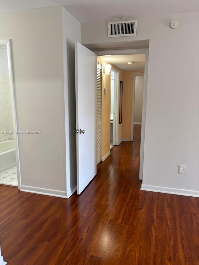 corridor with dark wood-type flooring