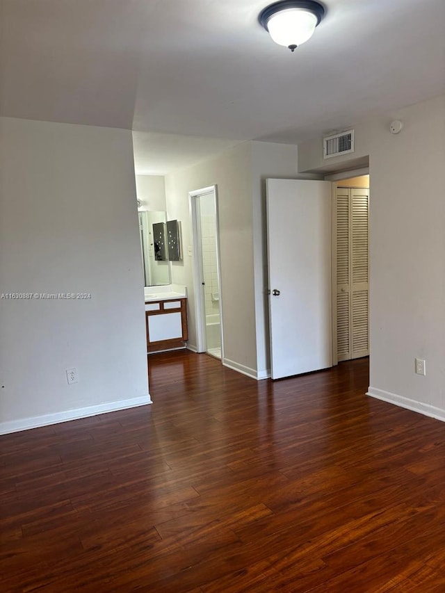 spare room with dark wood-type flooring