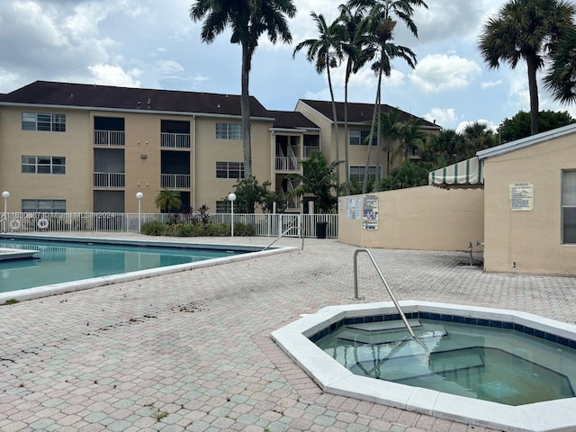 view of pool with a community hot tub