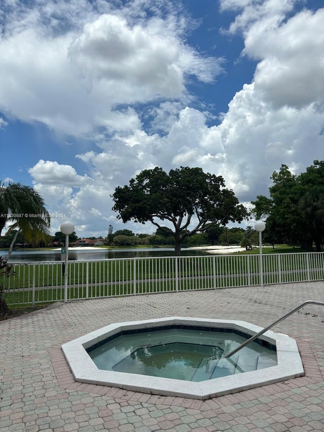 view of swimming pool featuring an in ground hot tub and a patio