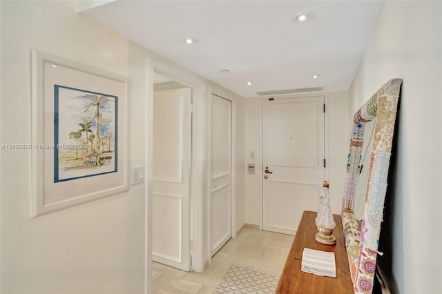 hall with light tile patterned flooring