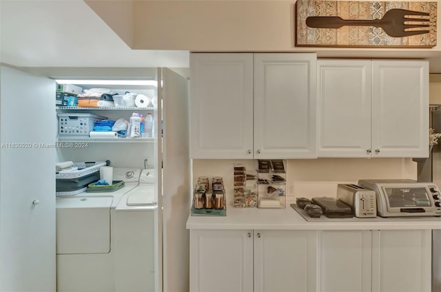 laundry area featuring washing machine and clothes dryer