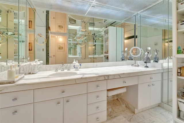 bathroom featuring walk in shower and vanity