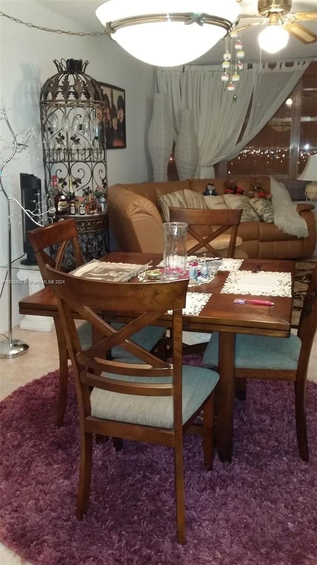 dining room featuring ceiling fan with notable chandelier