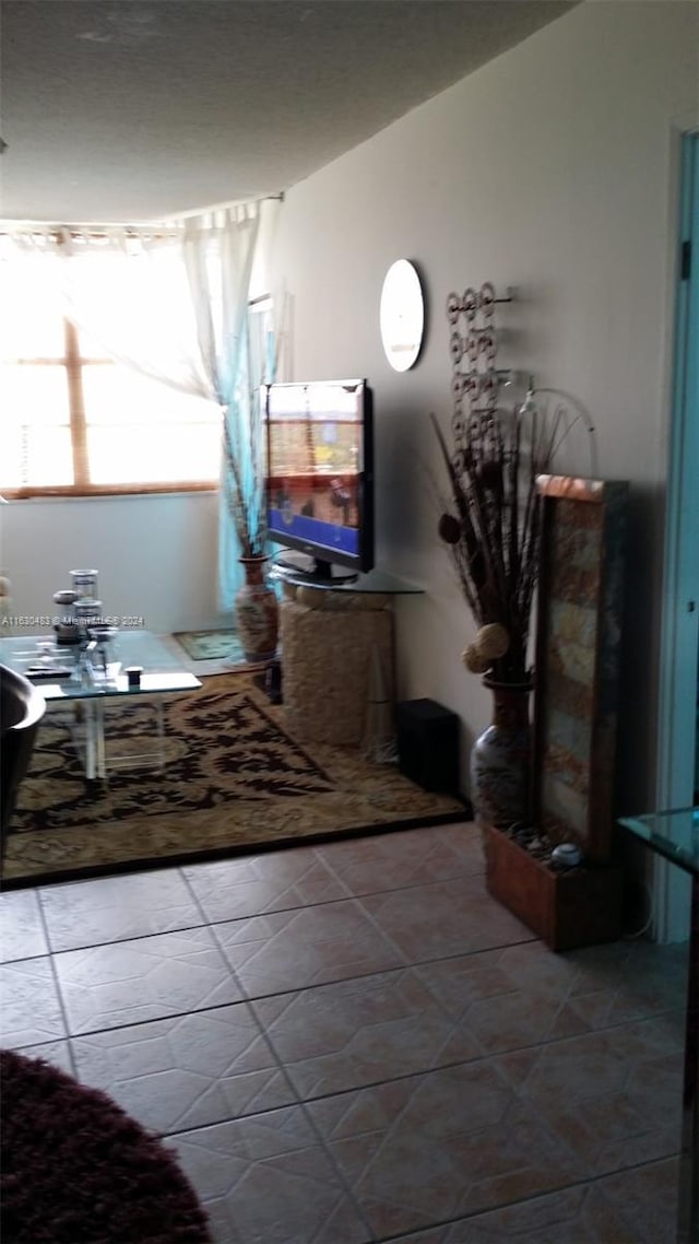 interior space featuring vaulted ceiling and tile patterned floors