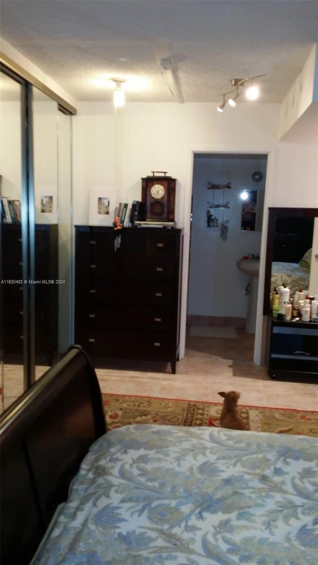 bedroom with ceiling fan and rail lighting