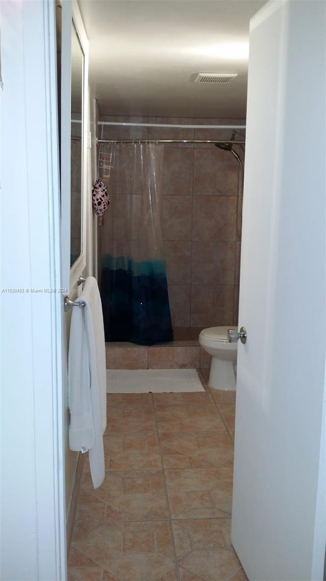 bathroom with tile patterned flooring and toilet