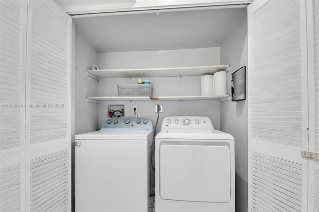 clothes washing area featuring washer and dryer