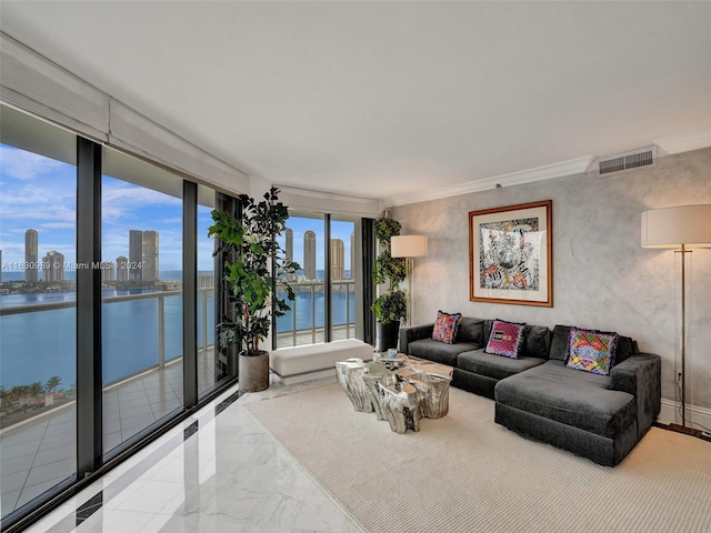 tiled living room with a water view and ornamental molding