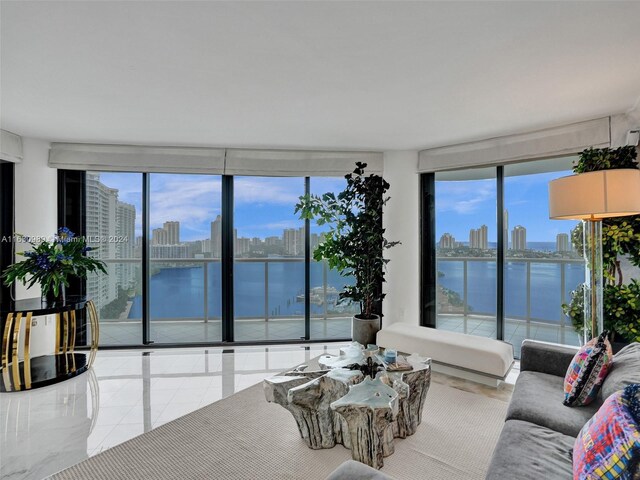 tiled living room with a water view and floor to ceiling windows