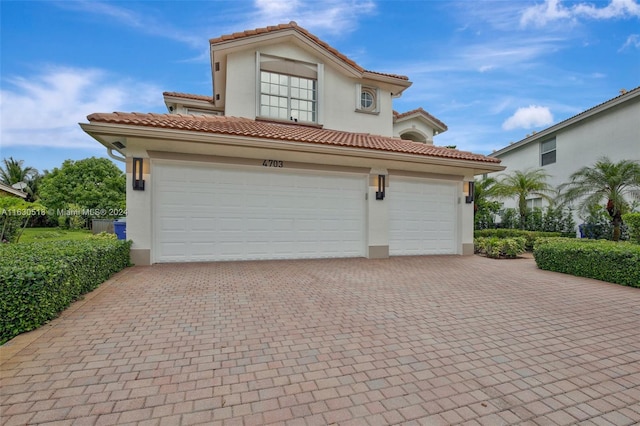 mediterranean / spanish house with a garage