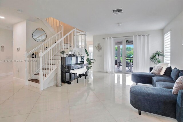 tiled living room featuring french doors