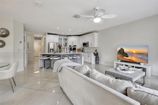 living room featuring light tile patterned flooring and ceiling fan