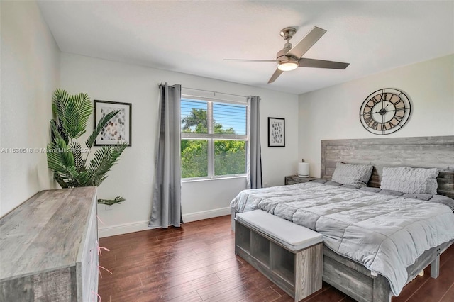 bedroom with dark hardwood / wood-style flooring and ceiling fan