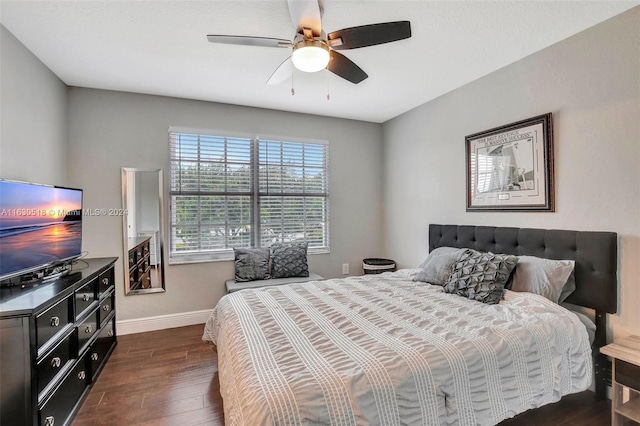 bedroom with ceiling fan and dark hardwood / wood-style flooring