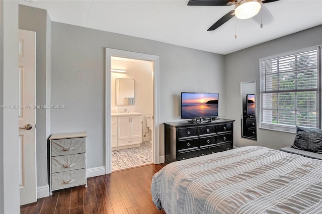 bedroom with ceiling fan, ensuite bathroom, dark hardwood / wood-style flooring, and sink