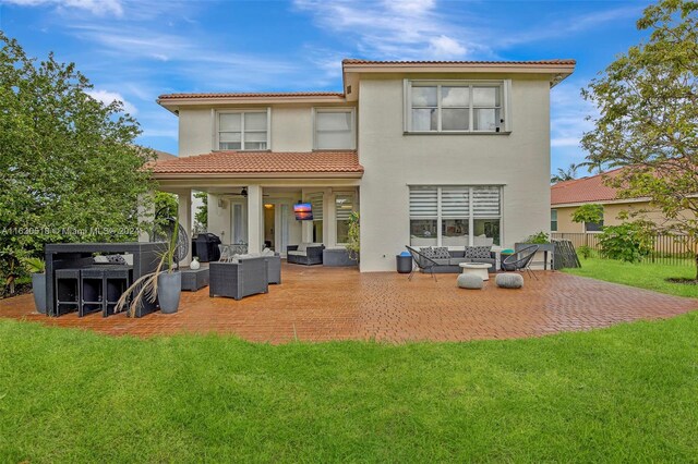 rear view of house with an outdoor living space, a patio, and a yard