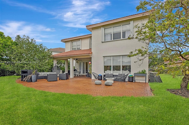 back of property featuring an outdoor living space, a yard, and ceiling fan