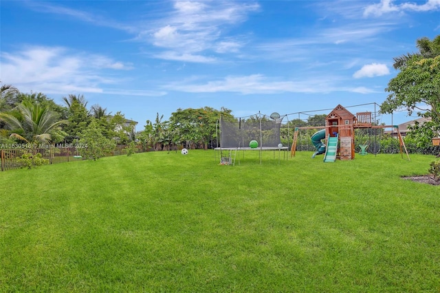 view of yard with a playground and a trampoline