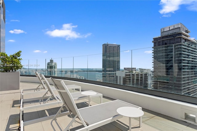 view of patio / terrace with a balcony and a water view