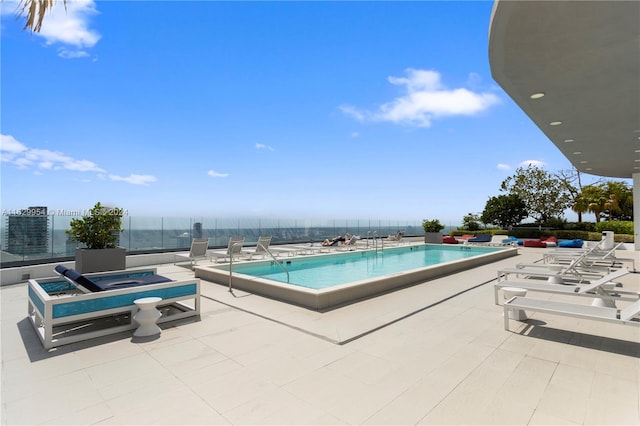 view of pool with a patio and a hot tub