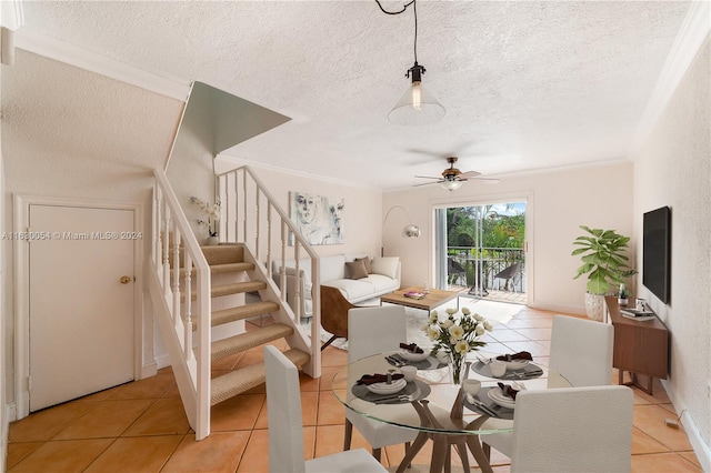 tiled dining area featuring ceiling fan, a textured ceiling, and ornamental molding