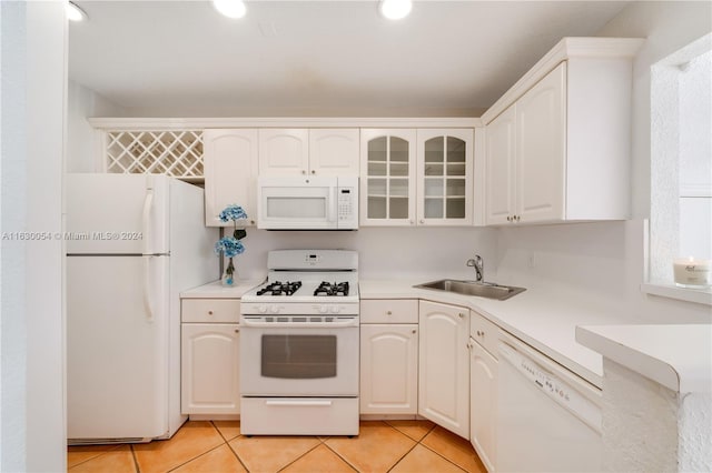 kitchen with white cabinets, white appliances, and sink