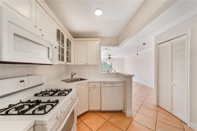 kitchen featuring light tile patterned flooring, sink, ceiling fan, a textured ceiling, and white appliances