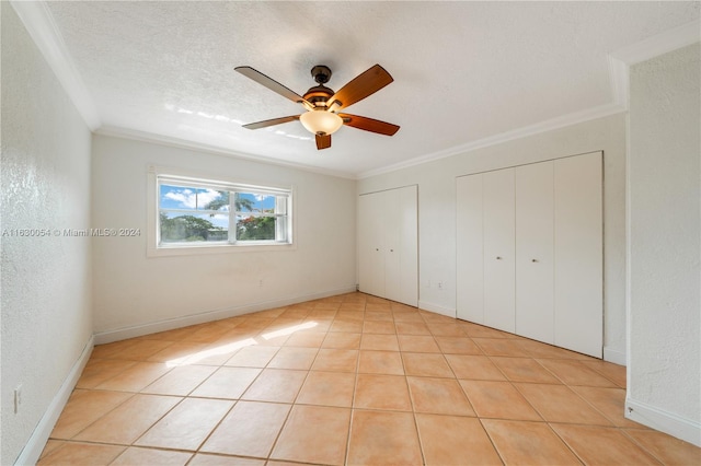 unfurnished bedroom with light tile patterned flooring, ceiling fan, and ornamental molding