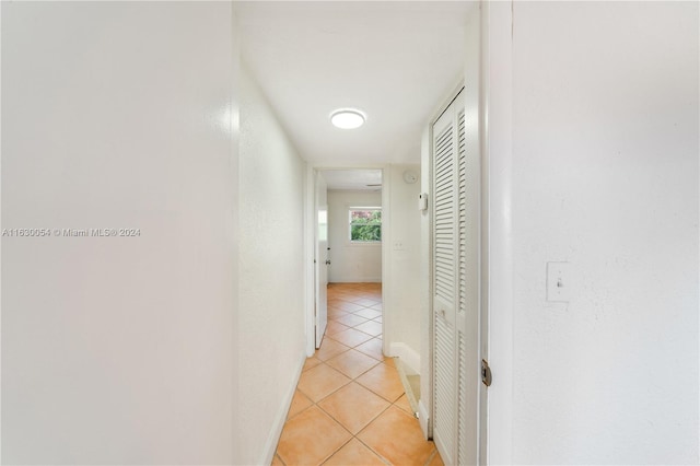 corridor with light tile patterned flooring