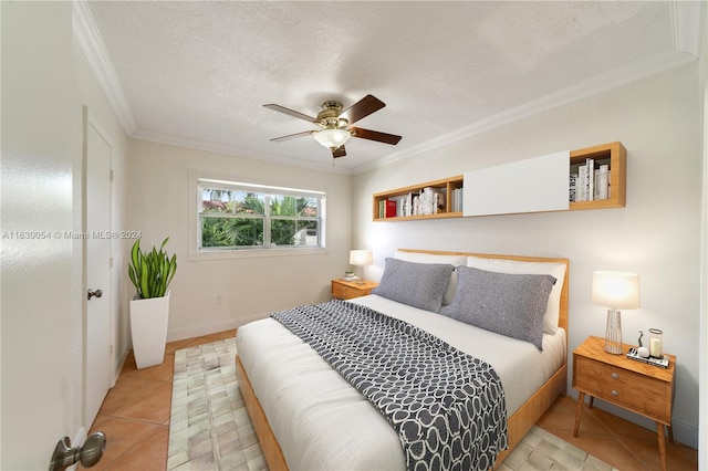 bedroom with ornamental molding, a textured ceiling, ceiling fan, and light tile patterned flooring