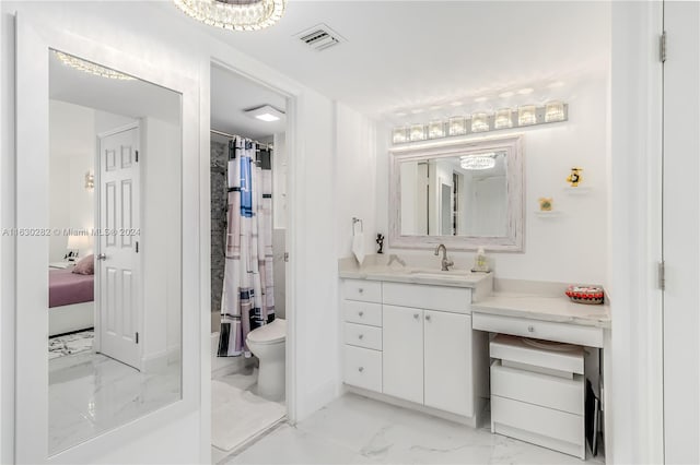 bathroom featuring vanity, tile patterned flooring, and toilet