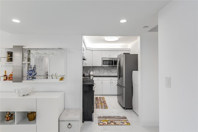 kitchen featuring white cabinetry, tasteful backsplash, stainless steel appliances, and light tile patterned floors