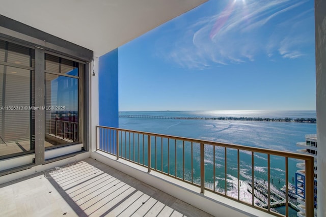 balcony featuring a water view and a view of the beach