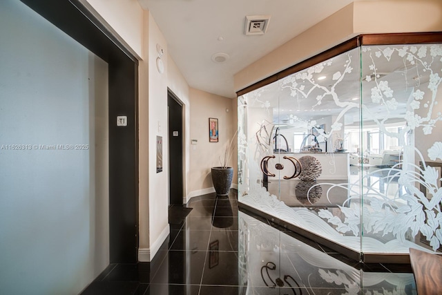 corridor with dark tile patterned floors