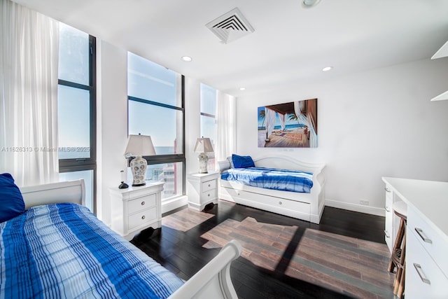 bedroom with dark hardwood / wood-style flooring