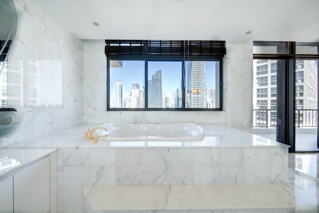 bathroom featuring a relaxing tiled tub