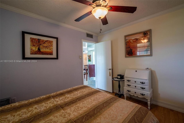 bedroom featuring crown molding, ceiling fan, and hardwood / wood-style flooring