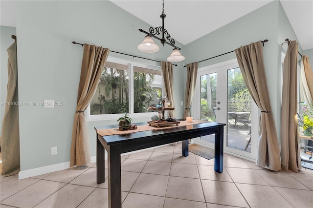 office with light tile patterned floors, french doors, baseboards, and vaulted ceiling