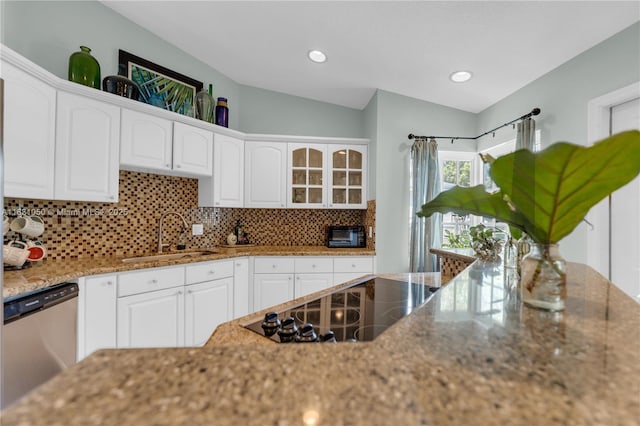 kitchen with a sink, white cabinetry, and stainless steel dishwasher