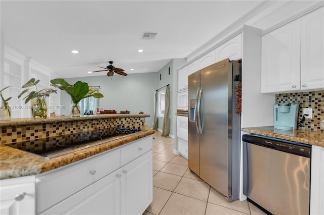 kitchen featuring tasteful backsplash, visible vents, light tile patterned floors, white cabinets, and stainless steel appliances