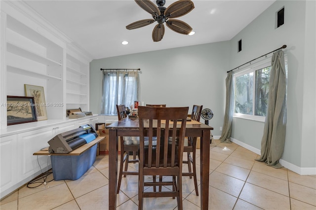 dining room with light tile patterned floors, built in shelves, and a healthy amount of sunlight