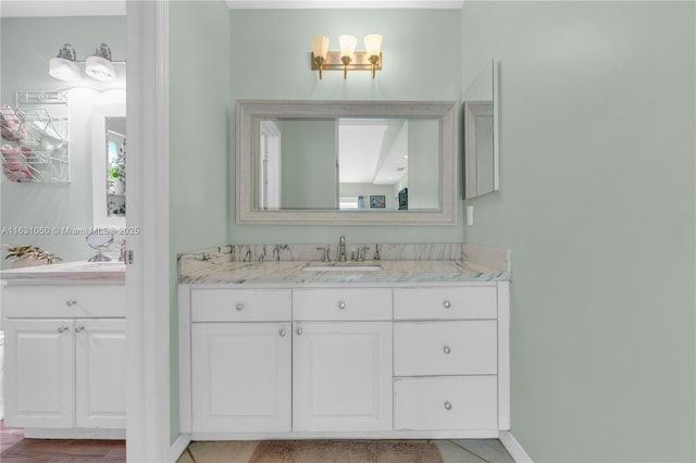 full bath featuring baseboards and vanity