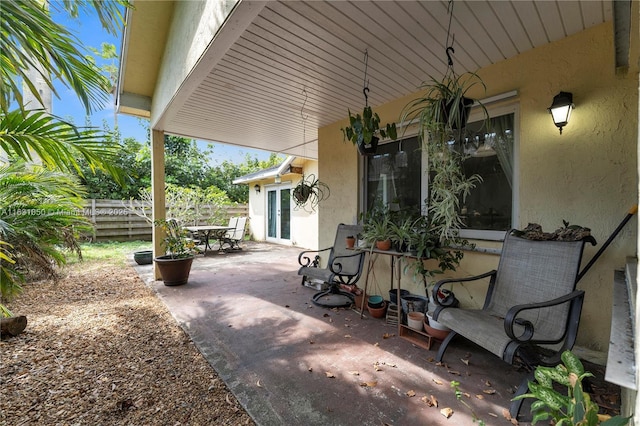 view of patio featuring fence