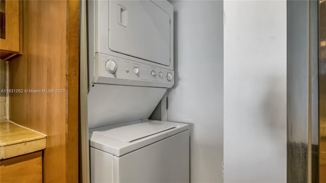 laundry area with stacked washer / dryer