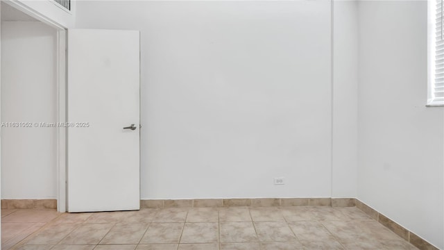 unfurnished room with light tile patterned floors